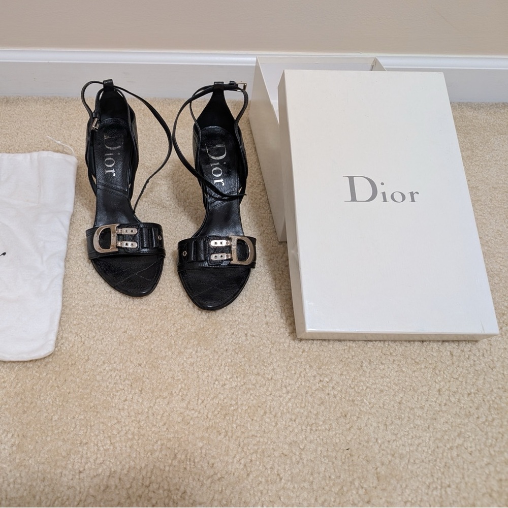 Christian Dior size 8 black leather heel with strap around ankle.
